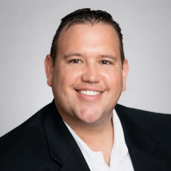 Professional headshot of Jason Bryan Ball, financial educator and policy analyst.